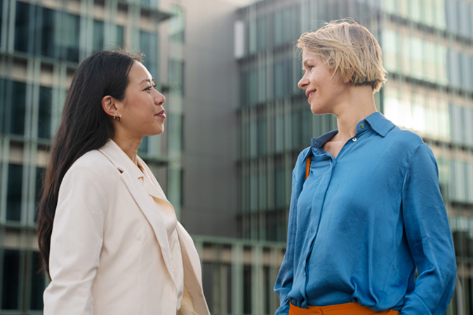 Two professionals outside office